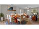 Open-concept living and dining area with modern furnishings, wood floors, and bright natural light at 2215 W Highland Ave, Phoenix, AZ 85015