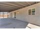 Covered patio with a stucco wall, lighting fixture and a view of the backyard at 2215 W Highland Ave, Phoenix, AZ 85015