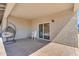 Covered patio featuring a hanging chair and a stack of white plastic chairs near a sliding glass door at 2215 W Highland Ave, Phoenix, AZ 85015