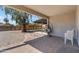 Relaxing covered patio with brick flooring, hanging chair, and a backyard view at 2215 W Highland Ave, Phoenix, AZ 85015