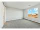 Inviting bedroom with a view of the outdoors and plush carpeting at 22351 S Manzanilla Rd, Buckeye, AZ 85326