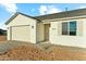 A charming home featuring a neutral paint scheme, a covered entryway, and a two-car garage at 22351 S Manzanilla Rd, Buckeye, AZ 85326