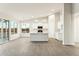 Modern kitchen with a center island, bright white cabinetry, and hardwood floors at 22351 S Manzanilla Rd, Buckeye, AZ 85326