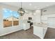 Bright kitchen featuring quartz countertops, an island, and hardwood-style floors at 22351 S Manzanilla Rd, Buckeye, AZ 85326