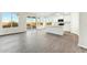 Living room with hardwood floors, bright natural light, and an open-concept kitchen at 22351 S Manzanilla Rd, Buckeye, AZ 85326