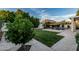 Lush backyard boasting a well-kept lawn, mature trees, and a refreshing pool with shade, perfect for outdoor living at 2330 E Stephens Pl, Chandler, AZ 85225