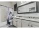 This bright bathroom has a double sink vanity with granite countertops, and framed mirror at 2330 E Stephens Pl, Chandler, AZ 85225