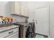 A modern laundry room featuring granite countertops and front loading washer and dryer at 2330 E Stephens Pl, Chandler, AZ 85225