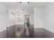 Bright and open living room with hardwood floors, arched entryways, and a front door view at 2330 E Stephens Pl, Chandler, AZ 85225