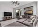 Spacious living room featuring a plush sectional sofa and sliding glass door to the backyard at 2330 E Stephens Pl, Chandler, AZ 85225