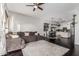 Bright living room with dark hardwood floors, ceiling fan, area rug, and gray sectional sofa at 2330 E Stephens Pl, Chandler, AZ 85225