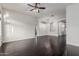 Spacious open-concept living room with hardwood floors, a chandelier, and an archway to the kitchen at 2330 E Stephens Pl, Chandler, AZ 85225