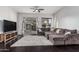 Bright living room with a cozy sectional sofa, and access to the patio through a sliding glass door at 2330 E Stephens Pl, Chandler, AZ 85225