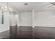 Open-concept living room with hardwood flooring, a chandelier, and an arched doorway at 2330 E Stephens Pl, Chandler, AZ 85225