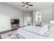 Well-lit primary bedroom with television and access to primary bathroom at 2330 E Stephens Pl, Chandler, AZ 85225