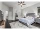 Beautiful main bedroom with ceiling fan, dark floors, and bathroom entrance at 2330 E Stephens Pl, Chandler, AZ 85225