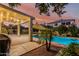This backyard features a covered patio, palm tree, and a private pool at 2330 E Stephens Pl, Chandler, AZ 85225