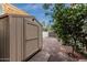 Backyard shed with durable siding, offering practical outdoor storage solutions alongside a flourishing citrus tree at 2330 E Stephens Pl, Chandler, AZ 85225