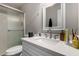 A bathroom is featured with a sink, faucet, mirror, counter, toilet, and shower with glass doors at 2514 N 22Nd Ave, Phoenix, AZ 85009