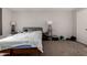 This bedroom features a queen bed, two lamps, one window and brown carpet at 2514 N 22Nd Ave, Phoenix, AZ 85009