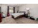 This bedroom features a queen bed, two lamps, one window and brown carpet at 2514 N 22Nd Ave, Phoenix, AZ 85009