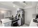 This kitchen features stainless steel appliances and has an open concept to the dining room at 2514 N 22Nd Ave, Phoenix, AZ 85009