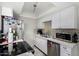 A kitchen is featured with stainless steel appliances, white countertops and cabinets, and mosaic-style backsplash at 2514 N 22Nd Ave, Phoenix, AZ 85009