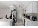 A kitchen is featured with stainless steel appliances, white countertops and cabinets, and mosaic-style backsplash at 2514 N 22Nd Ave, Phoenix, AZ 85009
