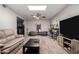 This living room features a cozy couch, two bean bags, shelves, a TV and a ceiling fan with overhead lighting at 2514 N 22Nd Ave, Phoenix, AZ 85009