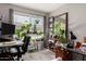Functional office space featuring a desk setup, natural light, and various plants at 2514 N 22Nd Ave, Phoenix, AZ 85009