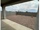 View of the private backyard featuring fresh gravel and a block wall for privacy and easy maintenance at 25183 N 183Rd Dr, Wittmann, AZ 85361