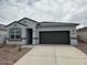 Charming single-story home features a neutral color palette, a covered entryway, and a two-car garage at 25183 N 183Rd Dr, Wittmann, AZ 85361