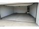 Spacious two car garage interior with a water heater and door to the interior of the house at 25183 N 183Rd Dr, Wittmann, AZ 85361