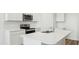 Bright kitchen with white cabinets, stainless steel appliances, a kitchen island and quartz countertops at 25183 N 183Rd Dr, Wittmann, AZ 85361