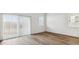 Light-filled living room with wood-look flooring and sliding glass door offers backyard access at 25183 N 183Rd Dr, Wittmann, AZ 85361