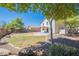 Large backyard with a partial view of the home, landscaping, and a concrete patio area at 2847 S 161St Dr, Goodyear, AZ 85338
