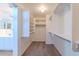 Bathroom featuring a view to the walk in closet with shelving next to dual sinks at 2847 S 161St Dr, Goodyear, AZ 85338
