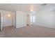 Large bedroom features plush carpeting with views into a bathroom and hallway at 2847 S 161St Dr, Goodyear, AZ 85338