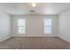 Bedroom featuring carpet, two large windows with blinds and overhead lighting at 2847 S 161St Dr, Goodyear, AZ 85338
