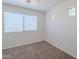 Bright bedroom with neutral carpet, and multiple windows providing natural light at 2847 S 161St Dr, Goodyear, AZ 85338