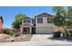 Two-story home featuring a two-car garage and desert landscaping at 2847 S 161St Dr, Goodyear, AZ 85338