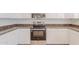 Modern kitchen has stainless steel stove and microwave plus white cabinets at 2847 S 161St Dr, Goodyear, AZ 85338