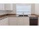 Close up of the kitchen's double basin sink and countertops with the dishwasher at 2847 S 161St Dr, Goodyear, AZ 85338
