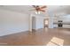 Open-concept living room with tile flooring flowing into the bright, white kitchen at 2847 S 161St Dr, Goodyear, AZ 85338