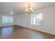 Bright living room featuring a ceiling fan, chandelier, and tile flooring at 2847 S 161St Dr, Goodyear, AZ 85338