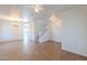 Bright open-concept living room with tile flooring, stairs, ceiling fan, chandelier, and white walls at 2847 S 161St Dr, Goodyear, AZ 85338
