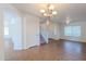 Open-concept space featuring a chandelier, easy access to the carpeted stairs, and stylish tile flooring at 2847 S 161St Dr, Goodyear, AZ 85338