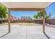 Covered patio view overlooking the backyard with a block wall and adjacent houses at 2847 S 161St Dr, Goodyear, AZ 85338