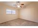 A comfortable bedroom with neutral walls, cozy carpet, and a ceiling fan for added comfort and a window at 31 W Loma Vista Dr # 102, Tempe, AZ 85282