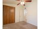 Bedroom featuring carpet, large closet, ceiling fan and a doorway that leads to the rest of the home at 31 W Loma Vista Dr # 102, Tempe, AZ 85282